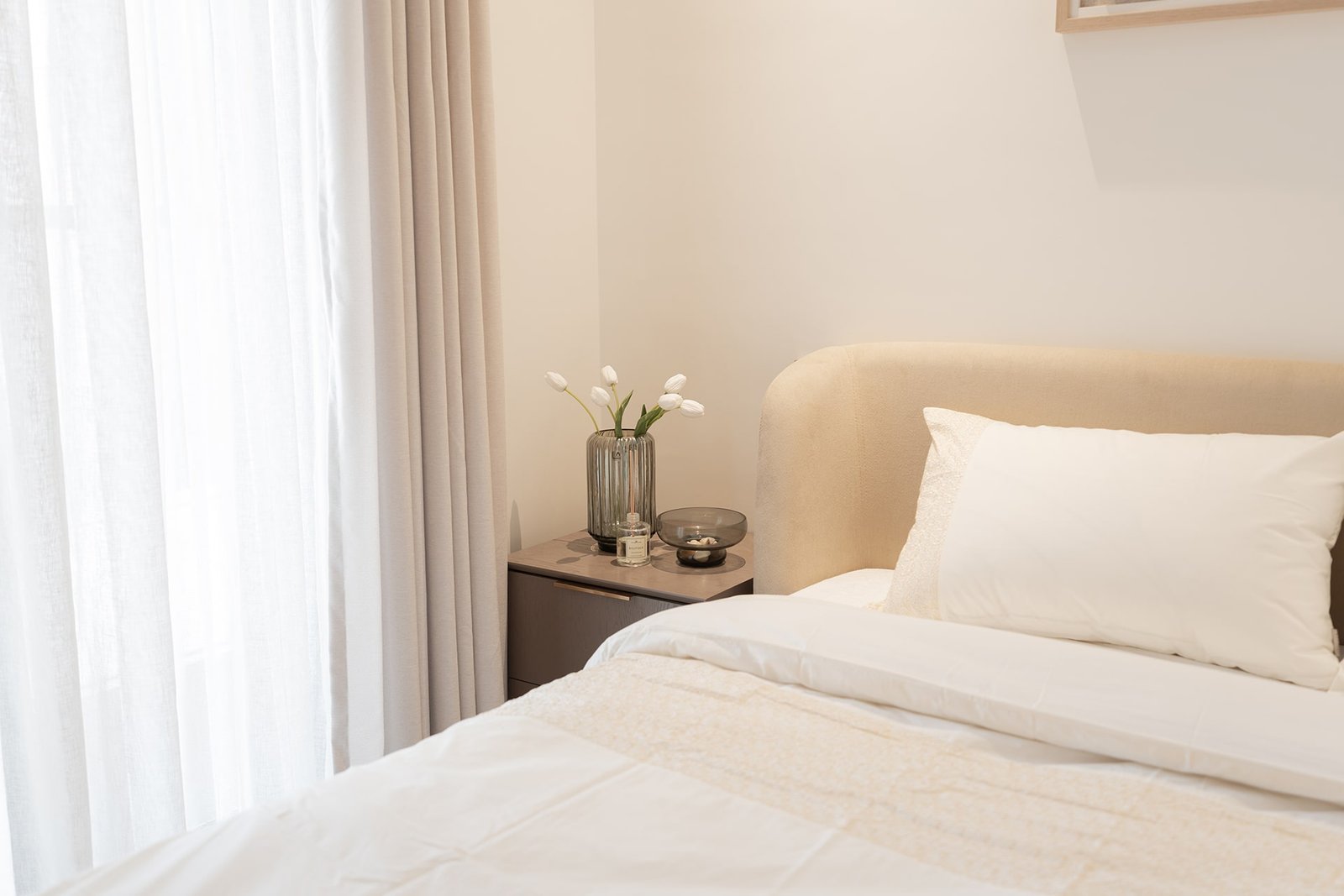 Minimalist and elegant bedroom design featuring natural light at Marissa Elite.